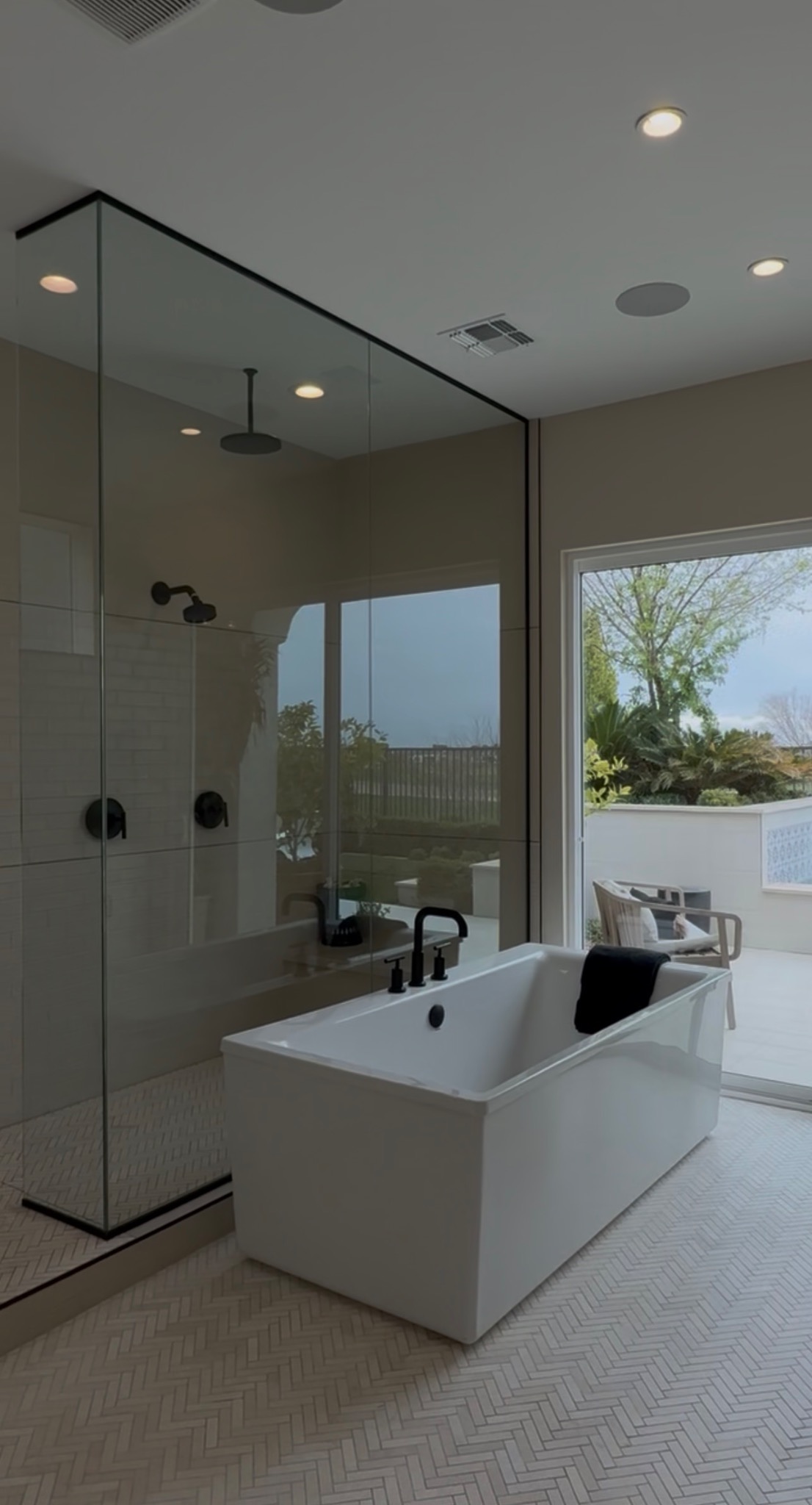 Modern bathroom remodel with glass shower and bathtub