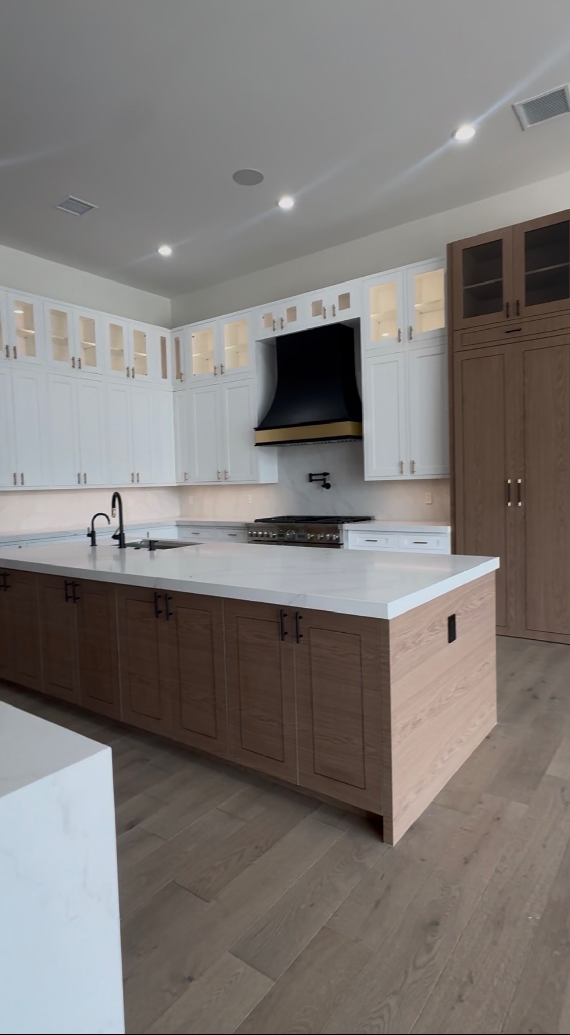 Luxury kitchen remodel with island and custom hood