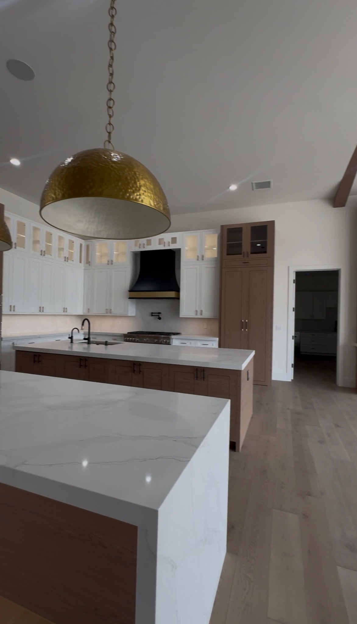 Custom kitchen remodel with white and wood cabinetry